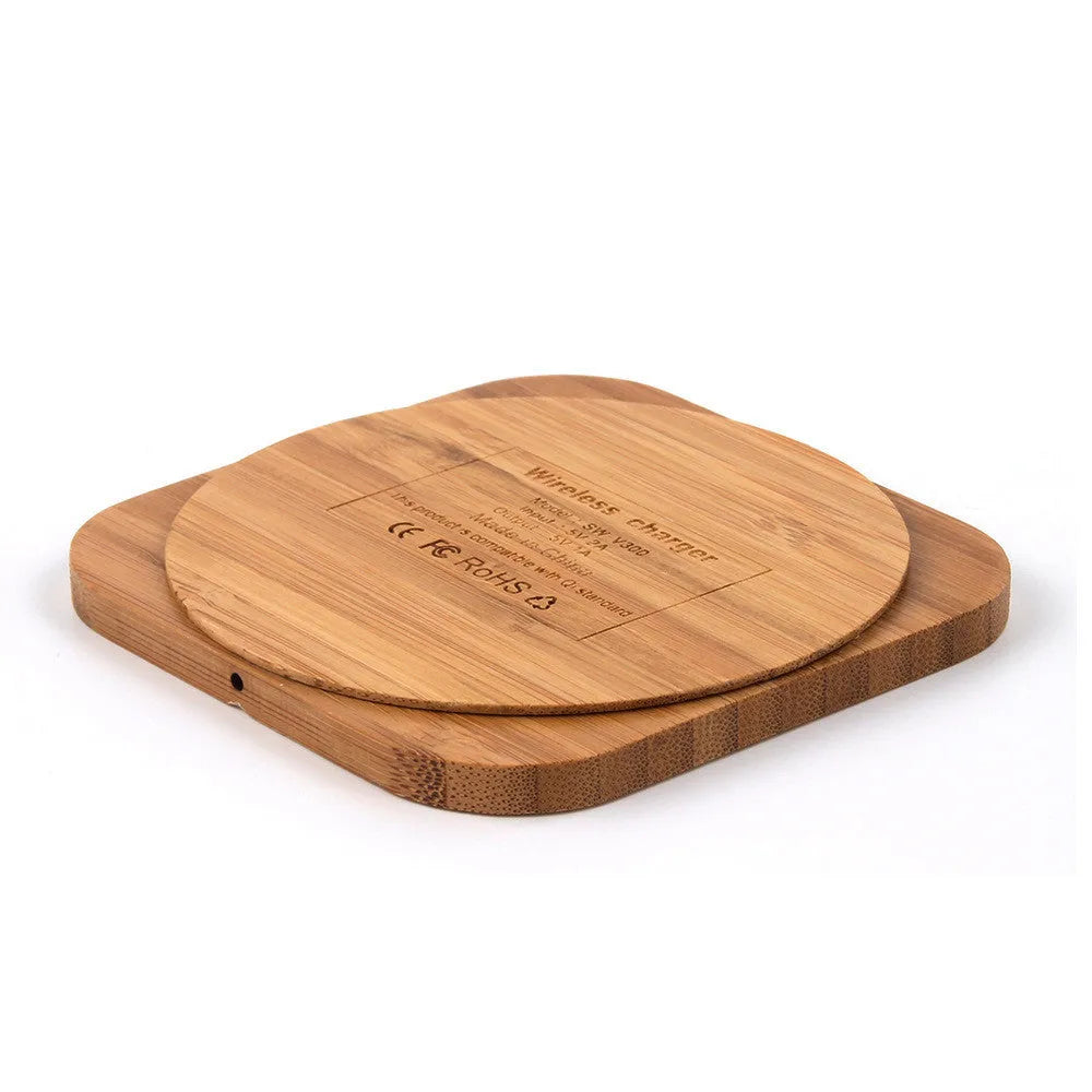 Brown heart-shaped wooden bamboo wireless charger on a table