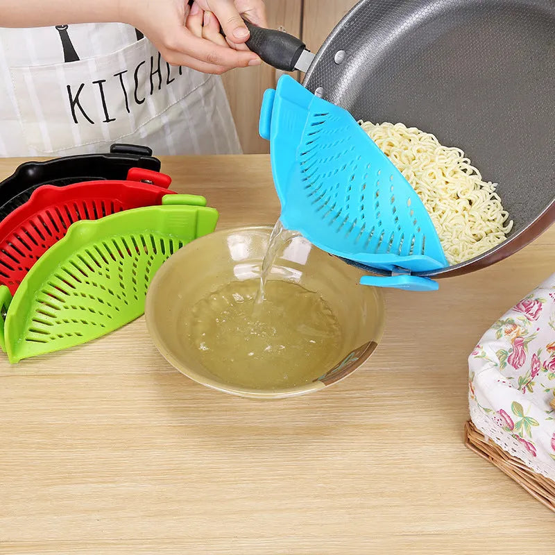 Silicone clip-on colander with stainless steel buckle attached to a pot, draining liquid, available in four colours.