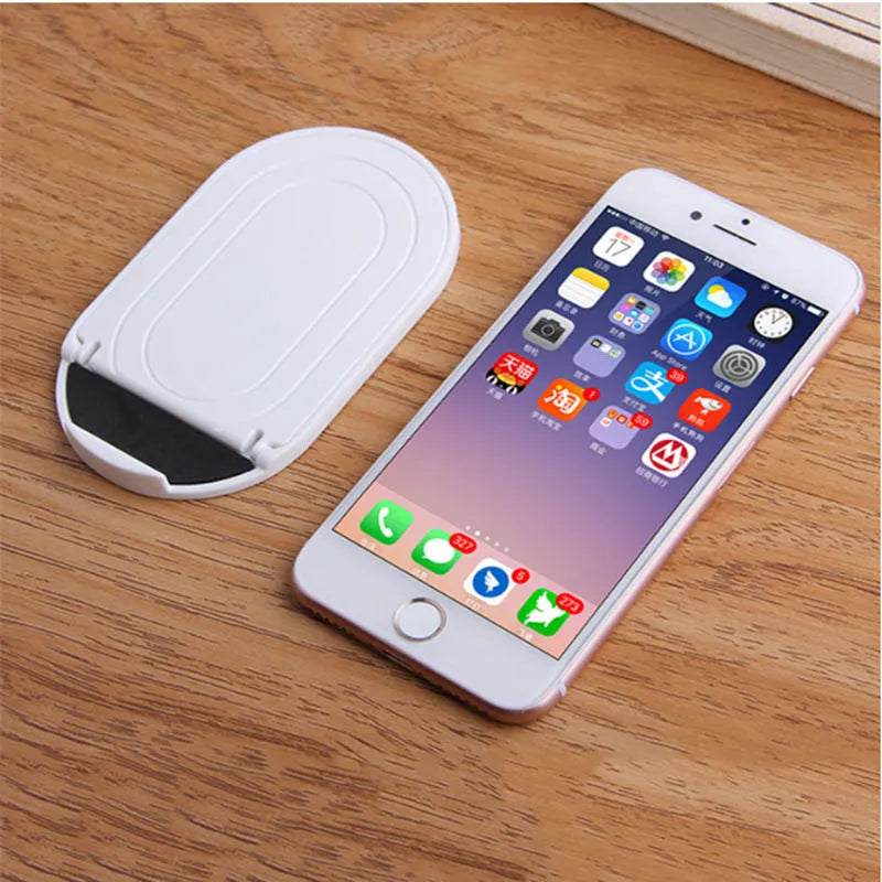 Plastic mobile phone stand bracket in six colour options showing adjustable angle design