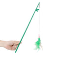 Green interactive cat feather wand toy with bells on a light background