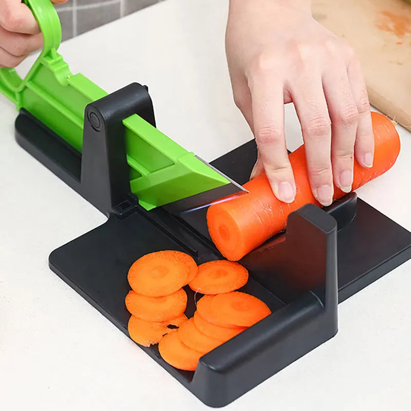 Green multifunctional vegetable cutter on a kitchen counter with stainless steel blade and plastic body