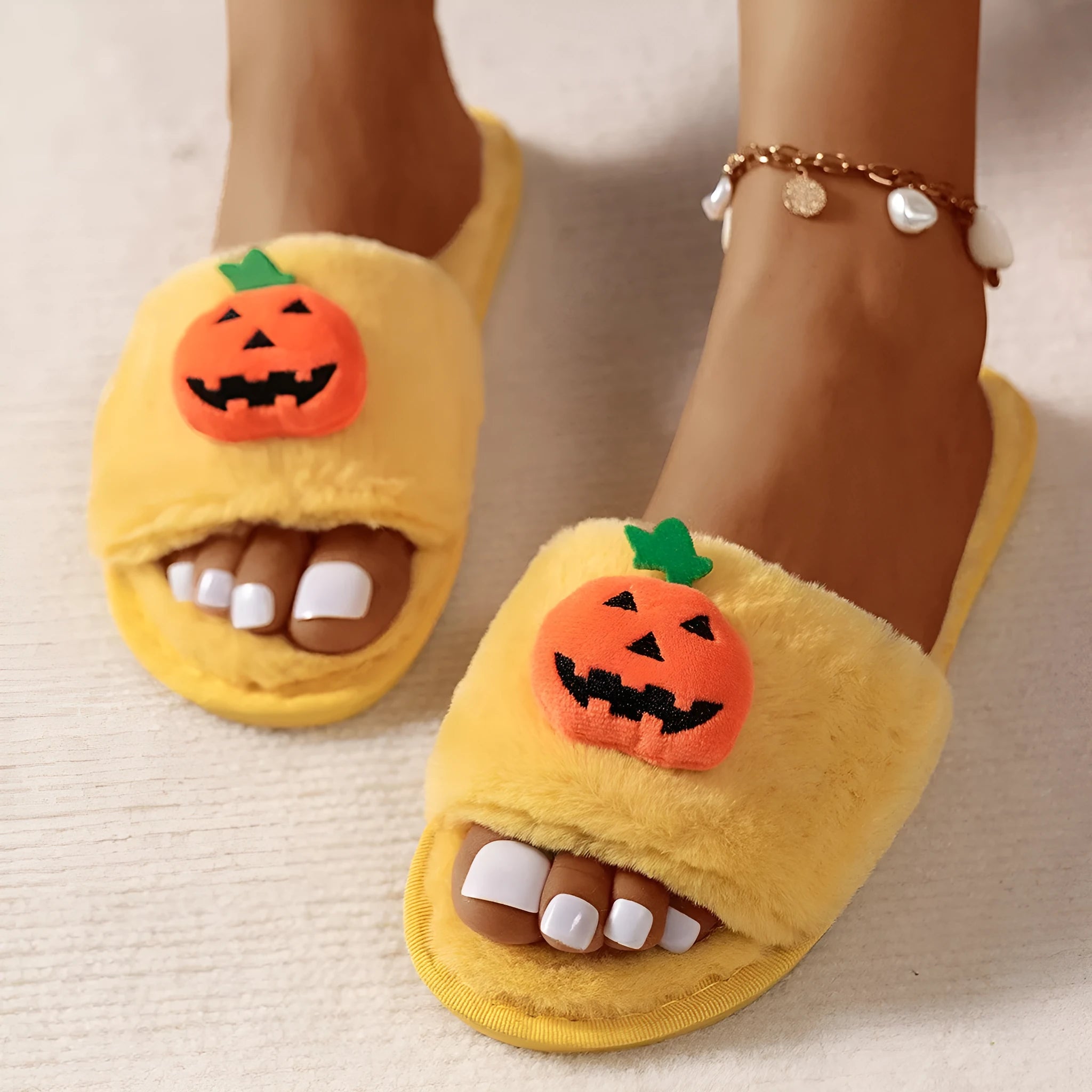 White and yellow pumpkin-themed plush open-toe slippers with a synthetic fur upper.
