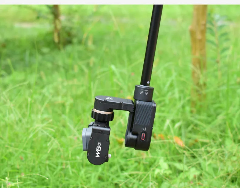 Retracted and extended views of a black aluminium selfie stick with phone holder and separate Bluetooth remote.