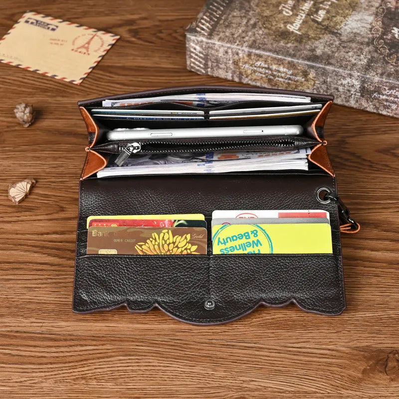 Brown genuine leather women's tri-fold wallet with embossed floral pattern showing interior compartments