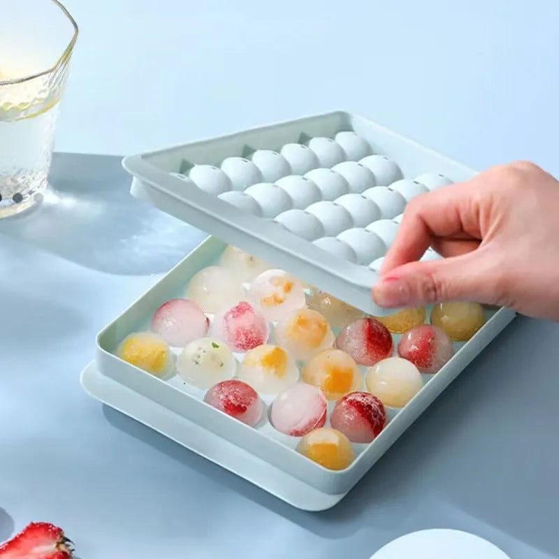 Blue silicone ice cube tray with lid showing 33 round ice cube moulds