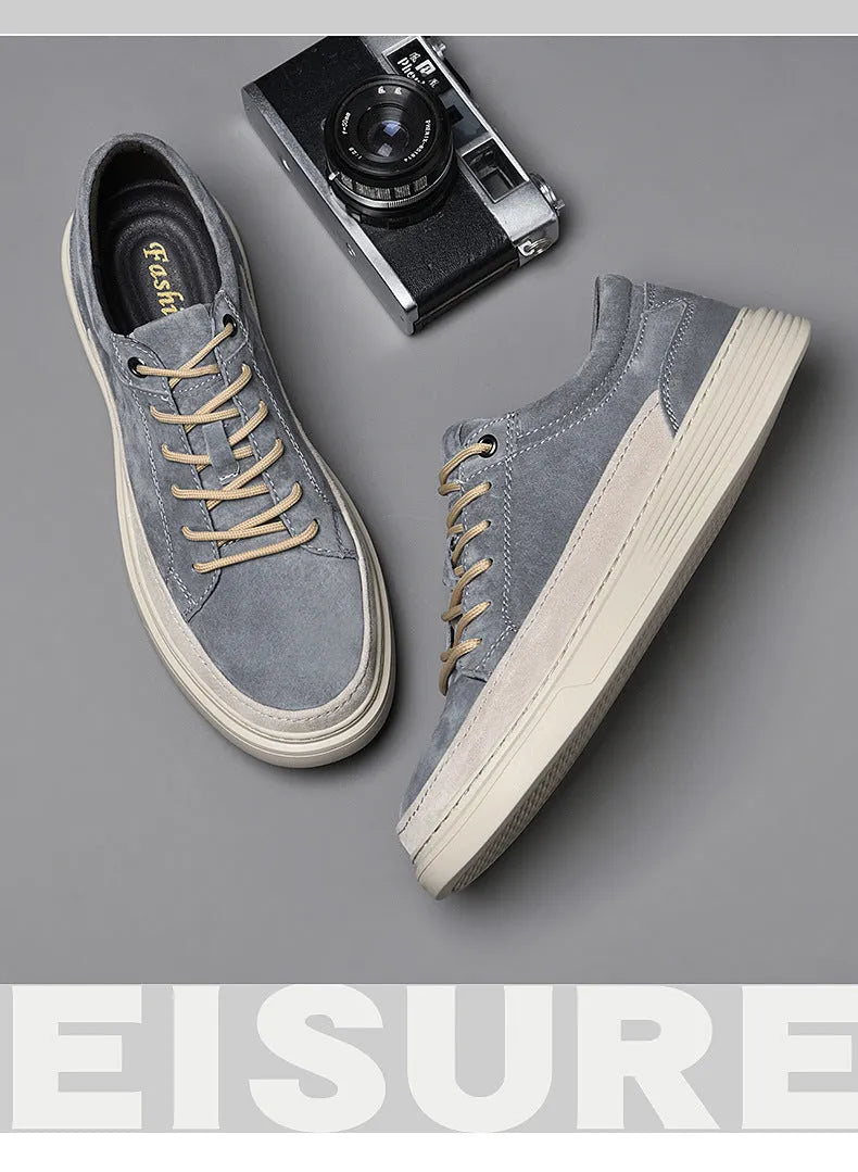 Men's grey low-top casual leather skate shoes with a round toe and flat rubber sole.