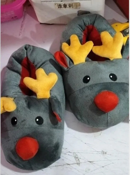 Grey super soft fleece home slippers with cute elk design, placed on a floor