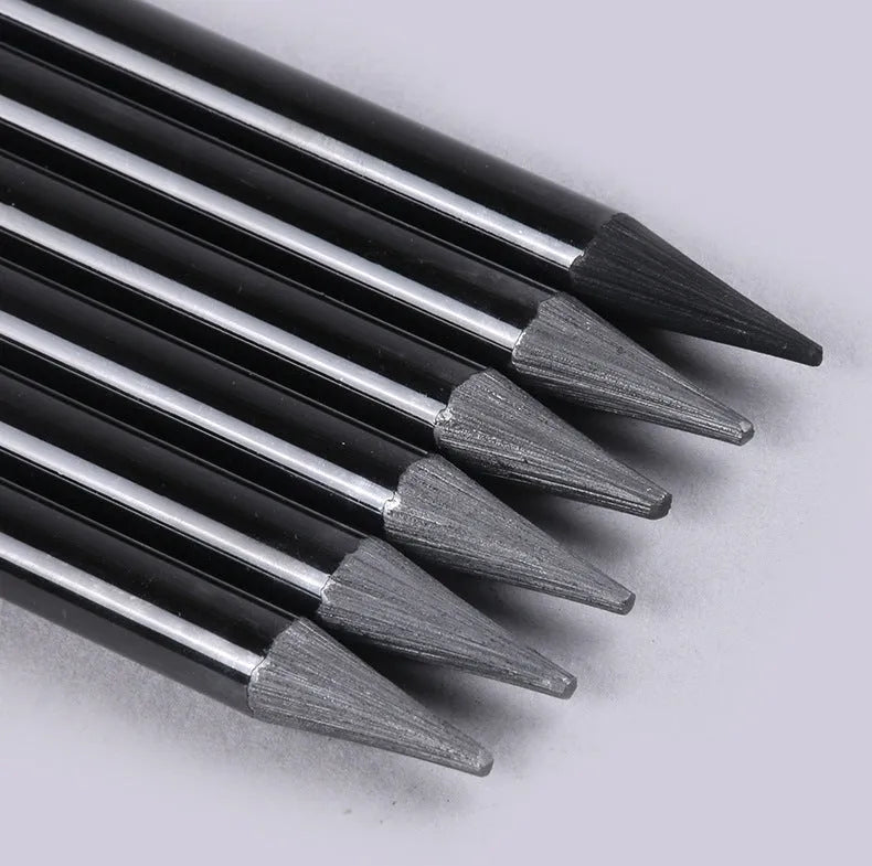 Set of six graphite pencils and three carbonized pencils in wooden casings on suction card packaging.