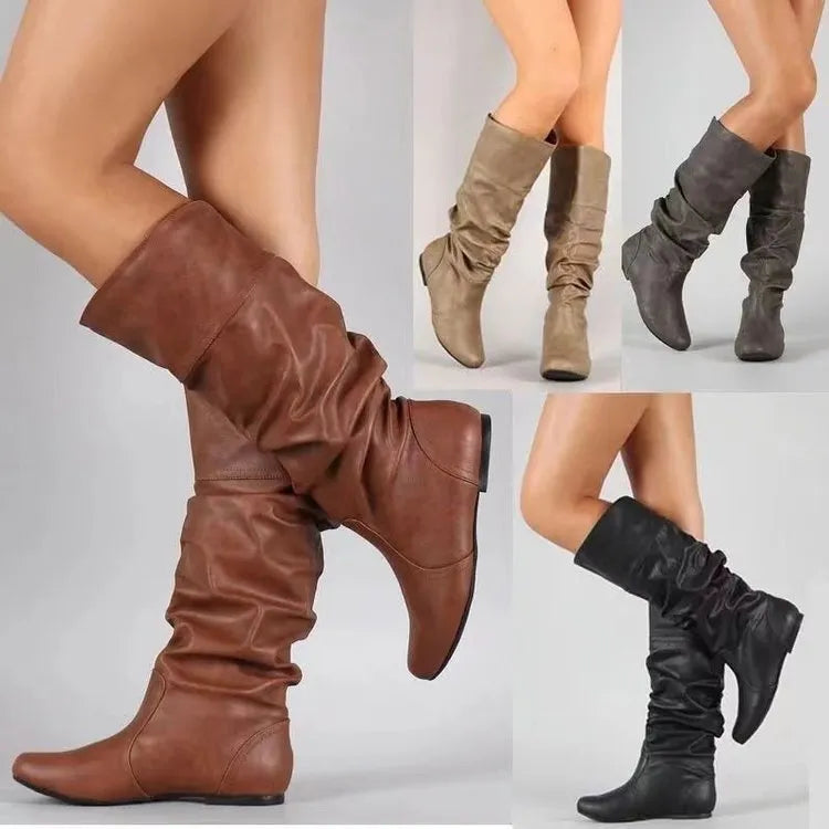 Women's black flat-heel slip-on long boots with a high shaft and round toe.