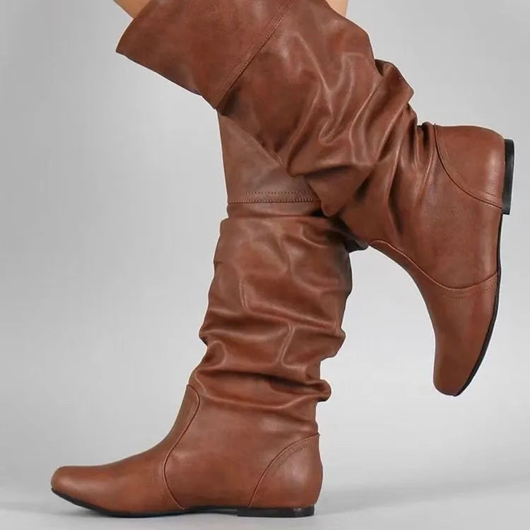 Women's black flat-heel slip-on long boots with a high shaft and round toe.
