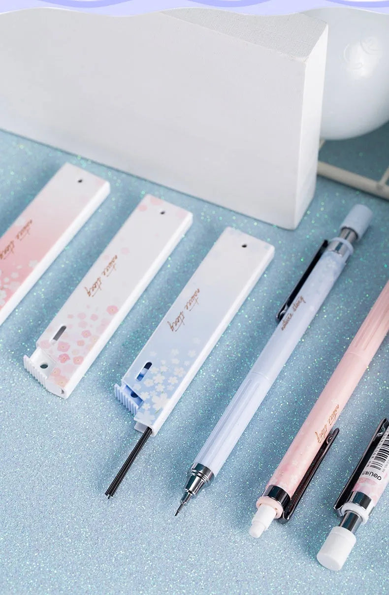 Cartoon automatic pencil set showing three 0.5mm pencils and HB refill boxes in mixed colours