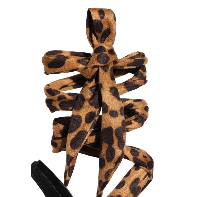 Light brown women's high heel sandals with leopard print, cross straps, and a thin high heel