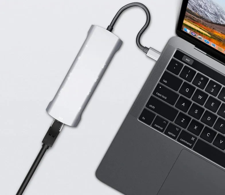 Grey aluminium alloy USB-C docking station with HDMI, VGA, USB 3.0, and Power Delivery ports