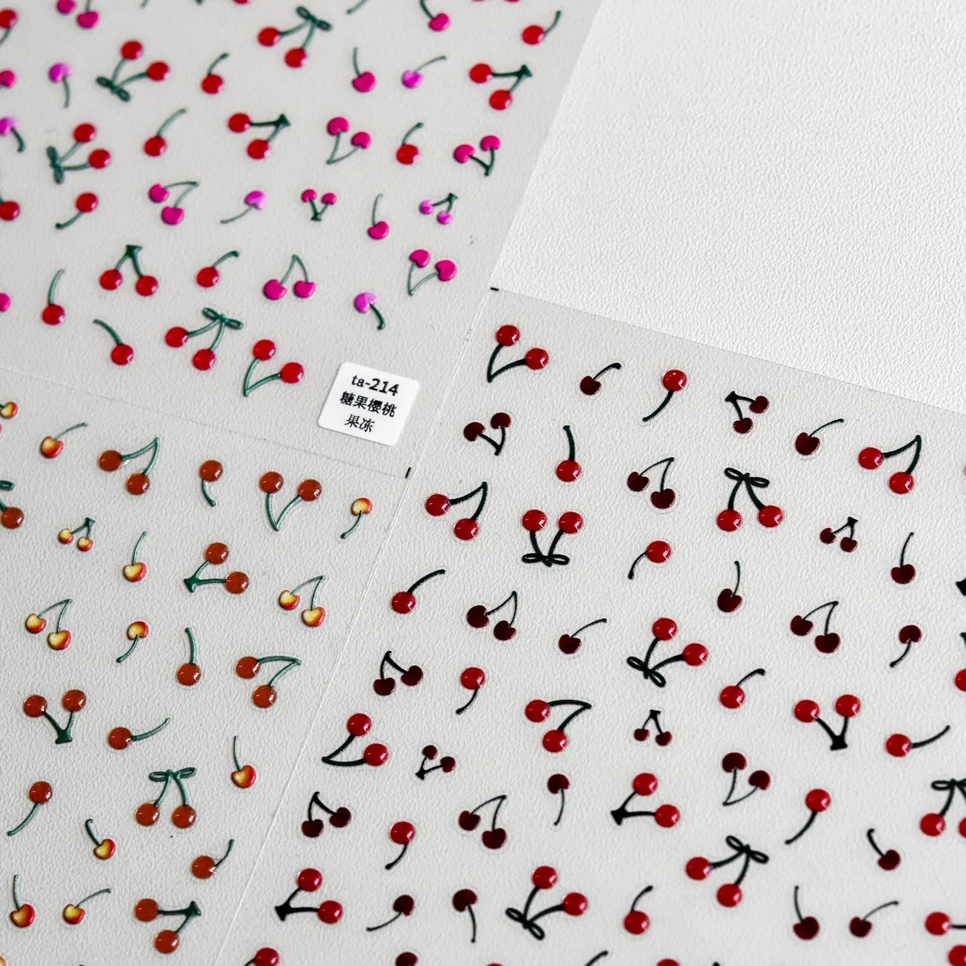 Jelly nail art sticker sheet with multiple cartoon cherry designs on a clear plastic backing