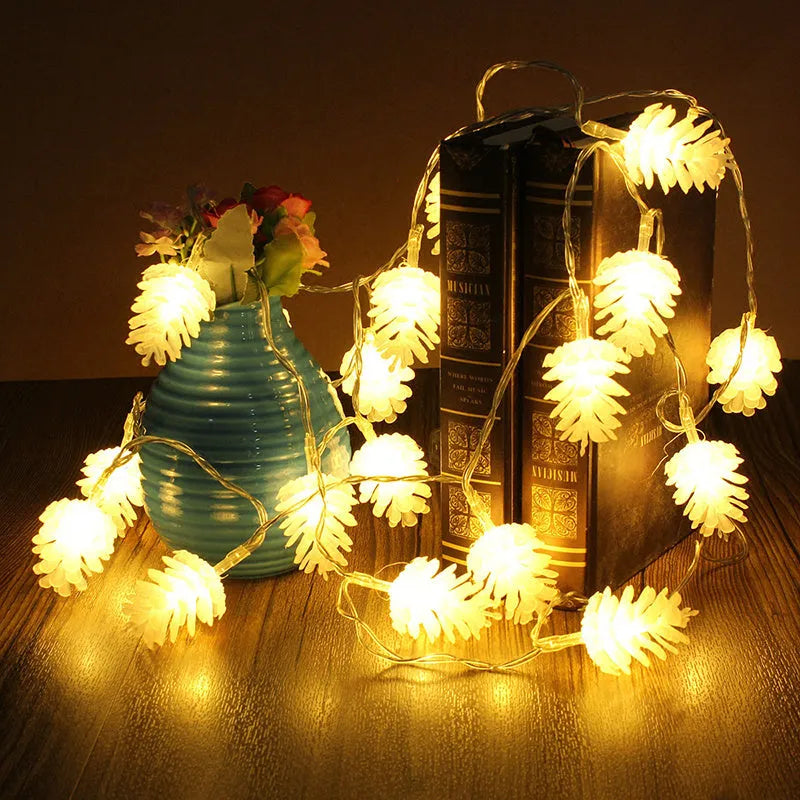 Warm white LED pine cone light string on a dark background, showing plastic shell details.