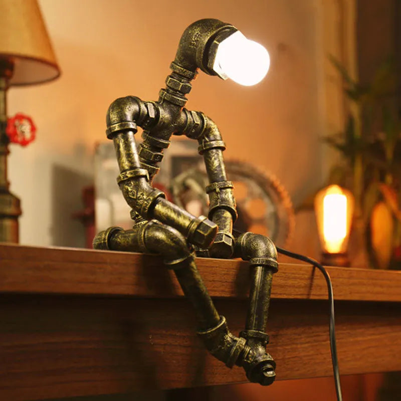 Green bronze industrial desk lamp with iron pipe design on wooden table
