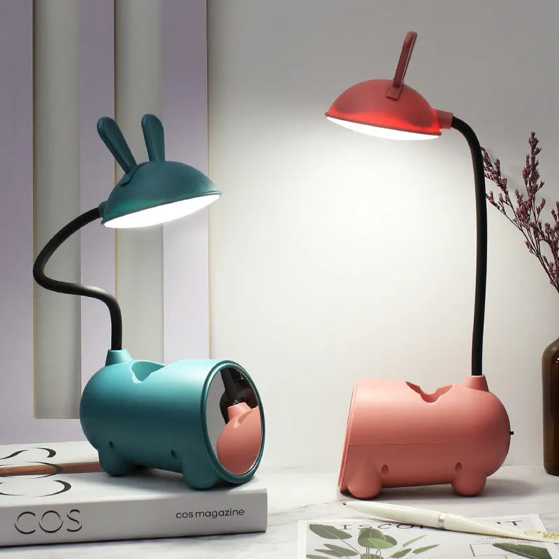 Cartoon-themed USB table lamp with pen container in green colour on desk