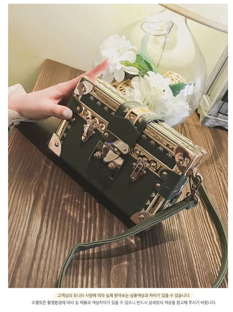 Hard-shell women's shoulder bag with single strap, flap closure, and decorative rivet details in black or green colour