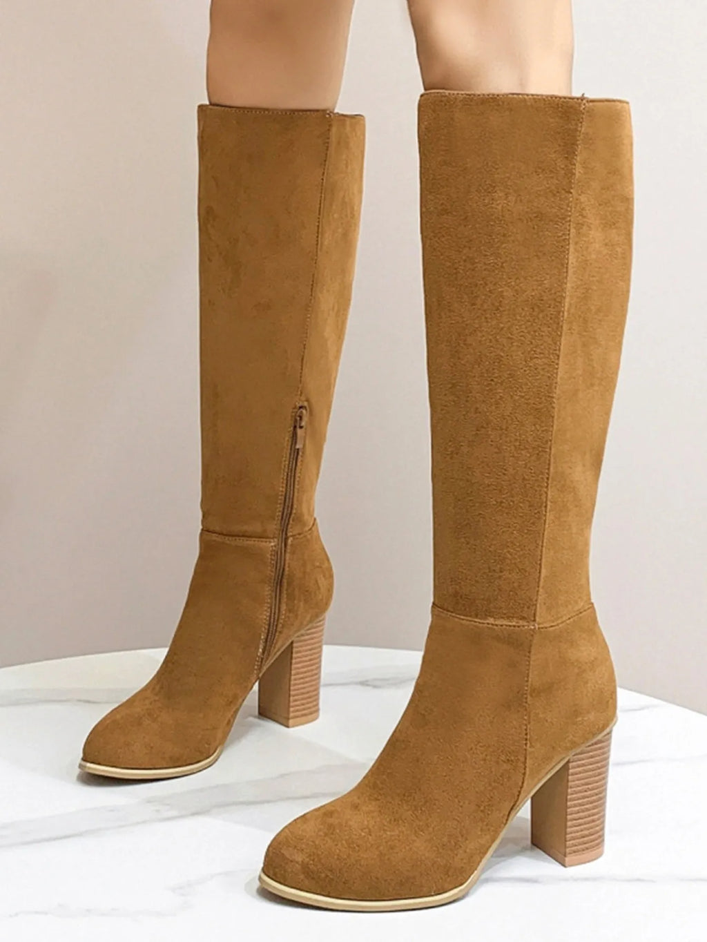Women's black square toe high heel fashion boot on a white background, showing the artificial PU upper and structured toe shape.