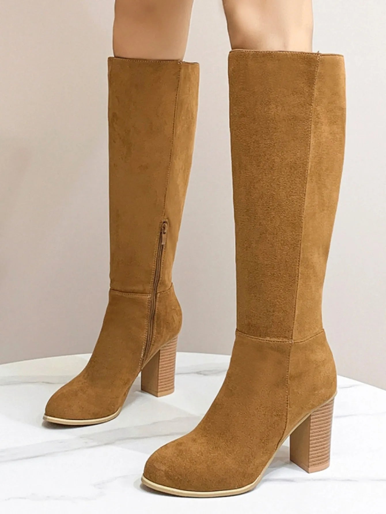 Women's black square toe high heel fashion boot on a white background, showing the artificial PU upper and structured toe shape.