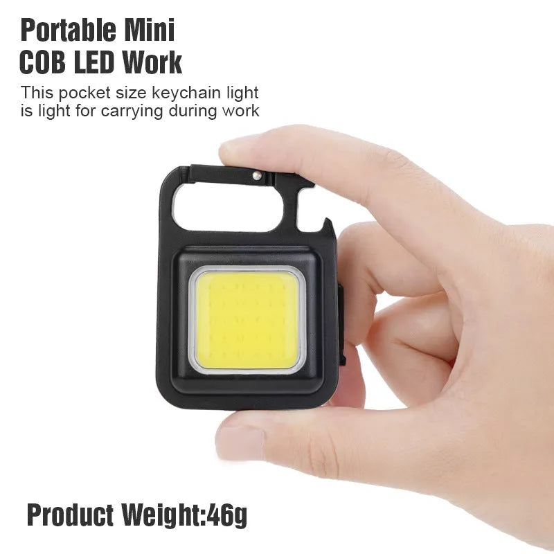 Black aluminium alloy keychain light with COB LED, magnetic base, and foldable handle on keyring