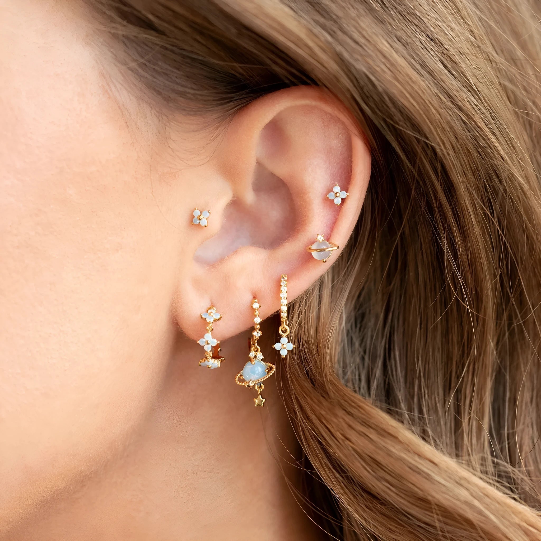 Gold and silver Japanese Korean style flower earrings studs with blue zircon mosaic detail.
