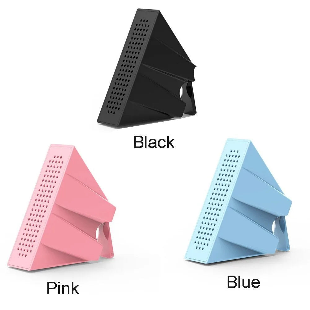 Portable black ABS plastic phone amplifier holder with an iPhone inserted, shown on a desktop.