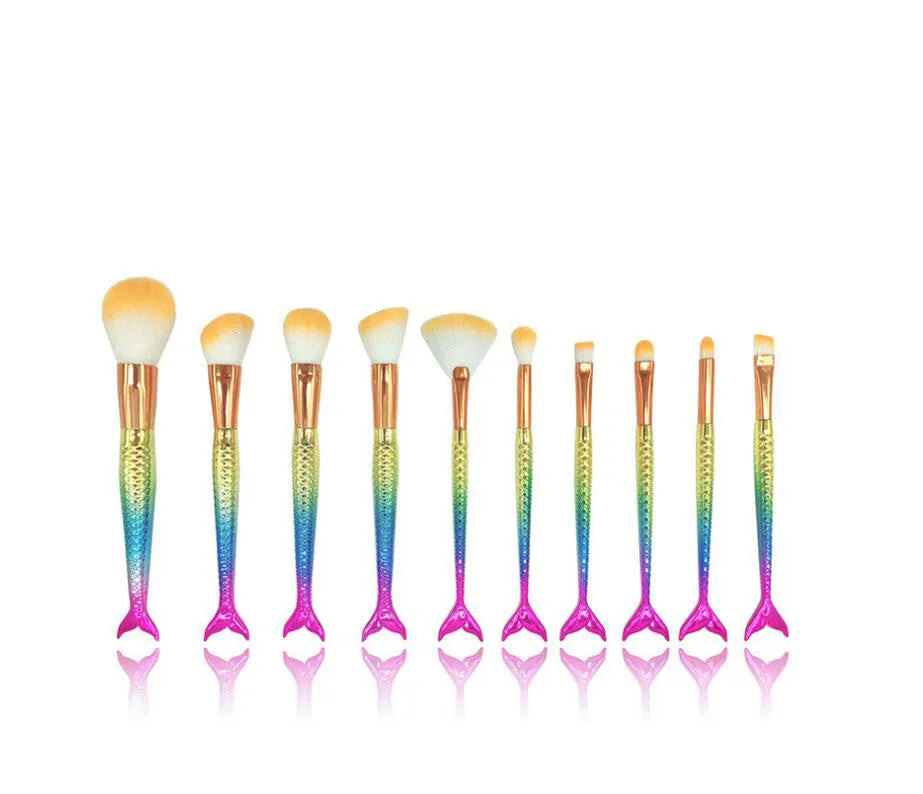 10 mermaid makeup brushes with multicolour nylon bristles and plastic handles laid flat