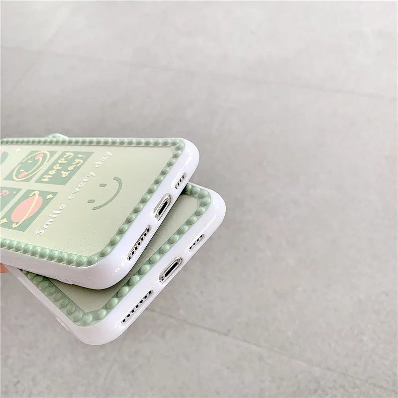Green flexible TPU iPhone case with geometric smiley face and polka dot frame design.