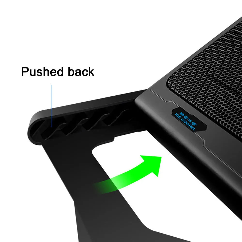 Black metal mesh laptop cooling board with USB cable on a desk next to a notebook.