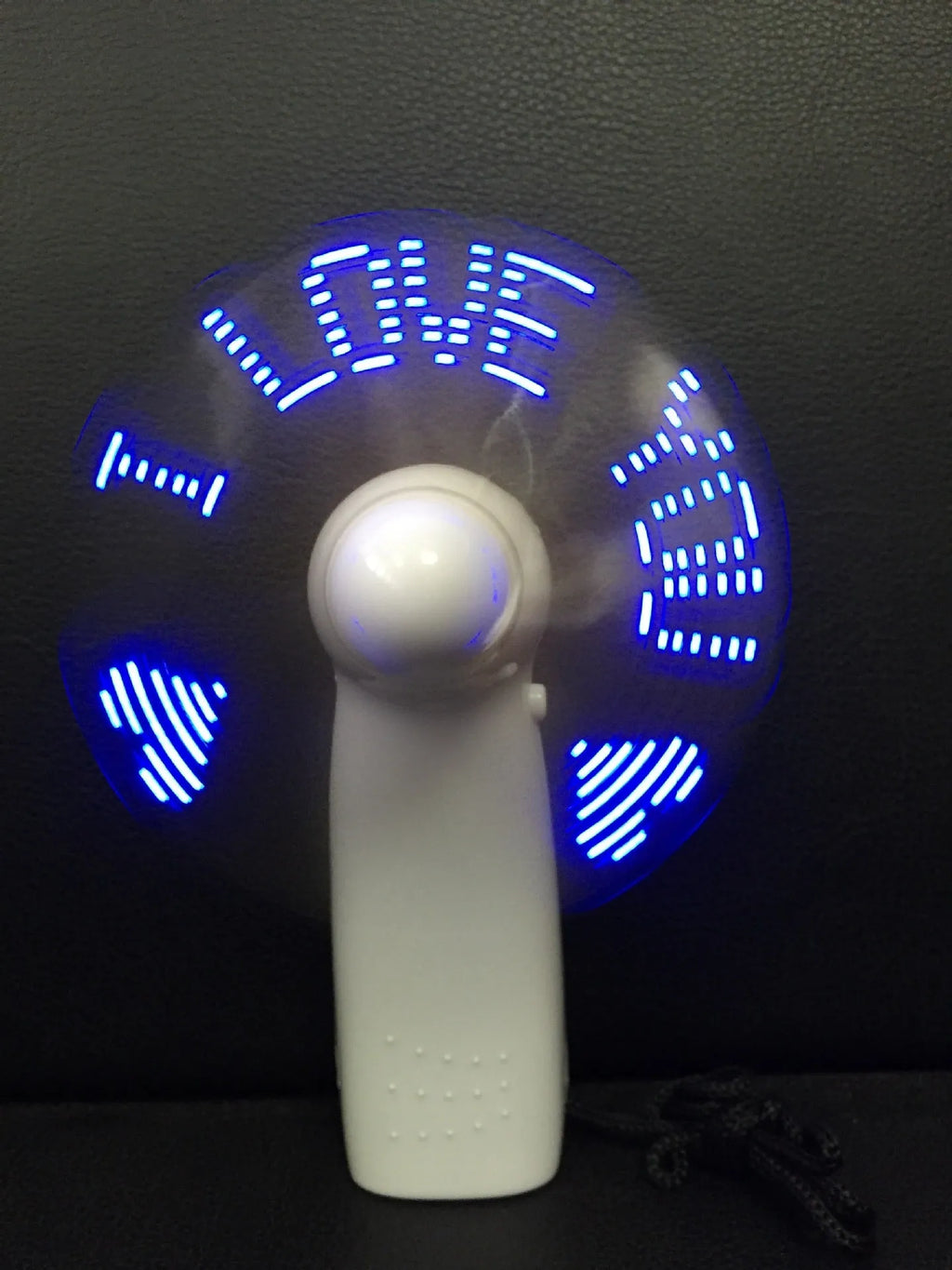 White handheld mini fan with flashing blue and red I love you LED display
