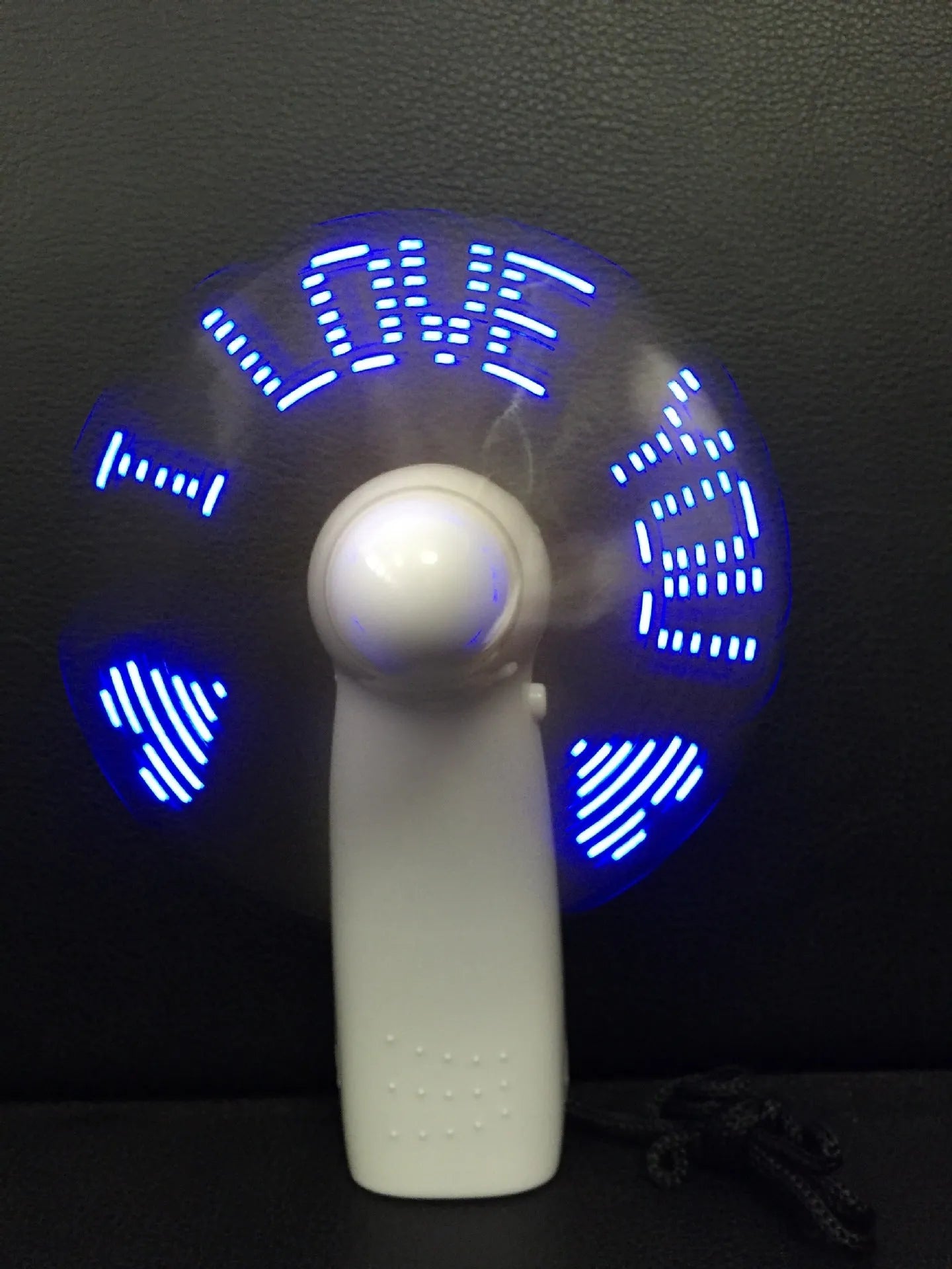 White handheld mini fan with flashing blue and red I love you LED display