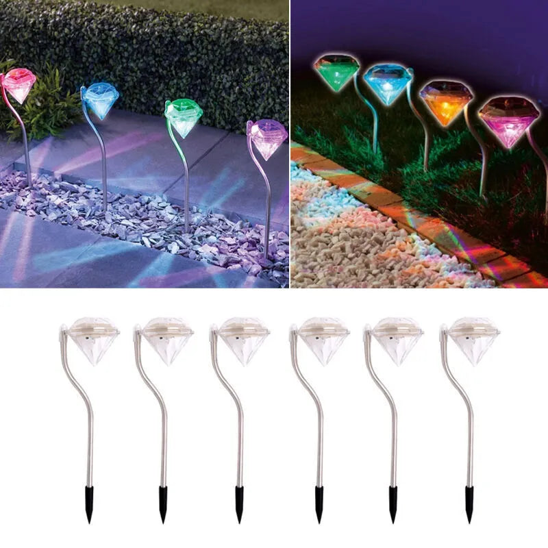 Solar powered diamond-shaped garden spotlight with adjustable angle on a grassy lawn.