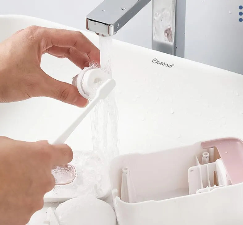 Automatic toothpaste dispenser unit in blue, grey, and pink colours made from ABS plastic.
