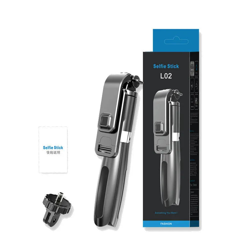 Black Bluetooth selfie stick with wireless remote and tripod extended on table, holding a smartphone in portrait orientation