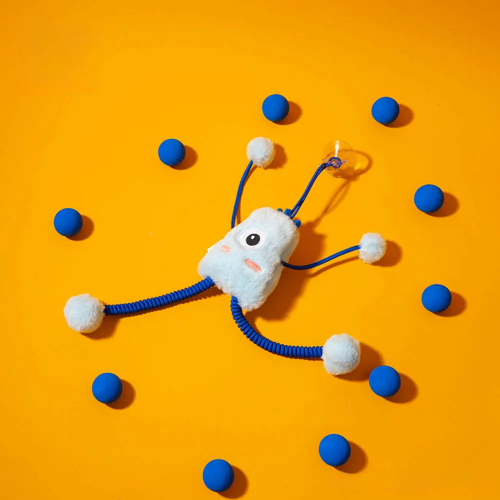 Blue plush cat toy with mint bell and elastic rope on floor