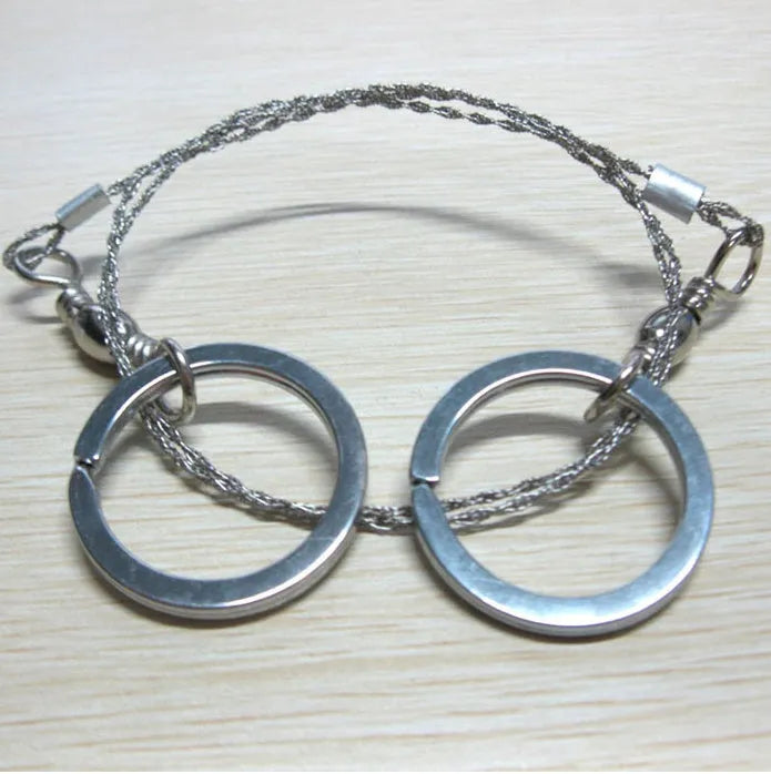 Survival wire saw tool with stainless steel blade and pull rings for outdoor cutting