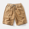 Men's khaki retro cargo shorts with a straight leg and fifth pants length on a white background.