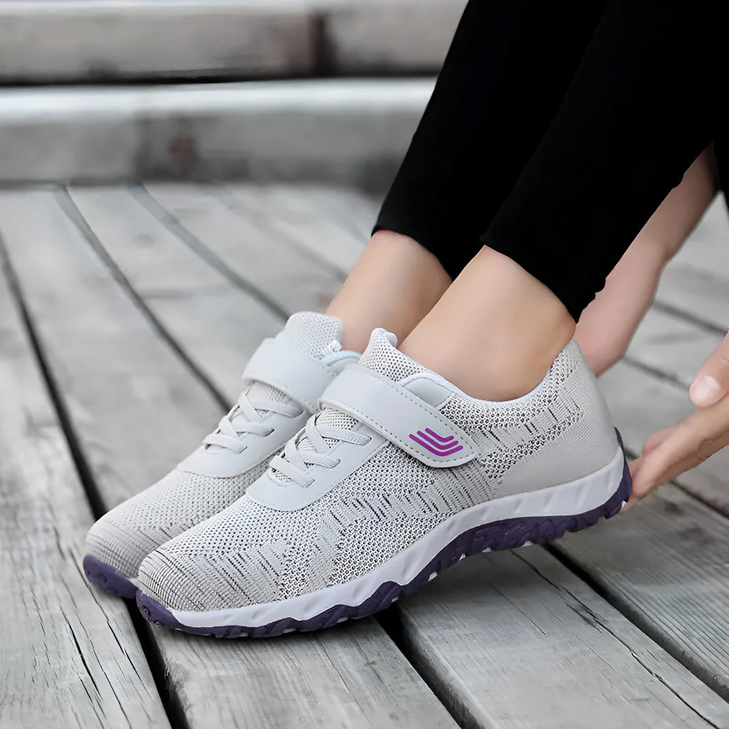 Women's grey purple wedge shoes with Velcro strap and mesh upper on a composite sole.