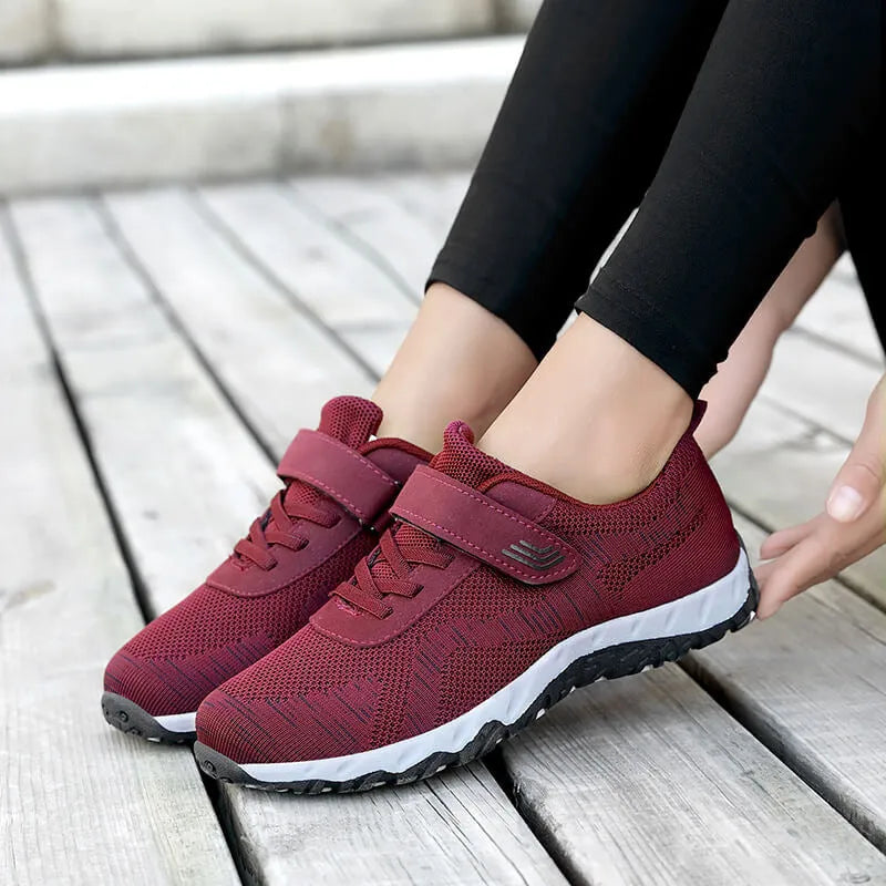 Women's grey purple wedge shoes with Velcro strap and mesh upper on a composite sole.