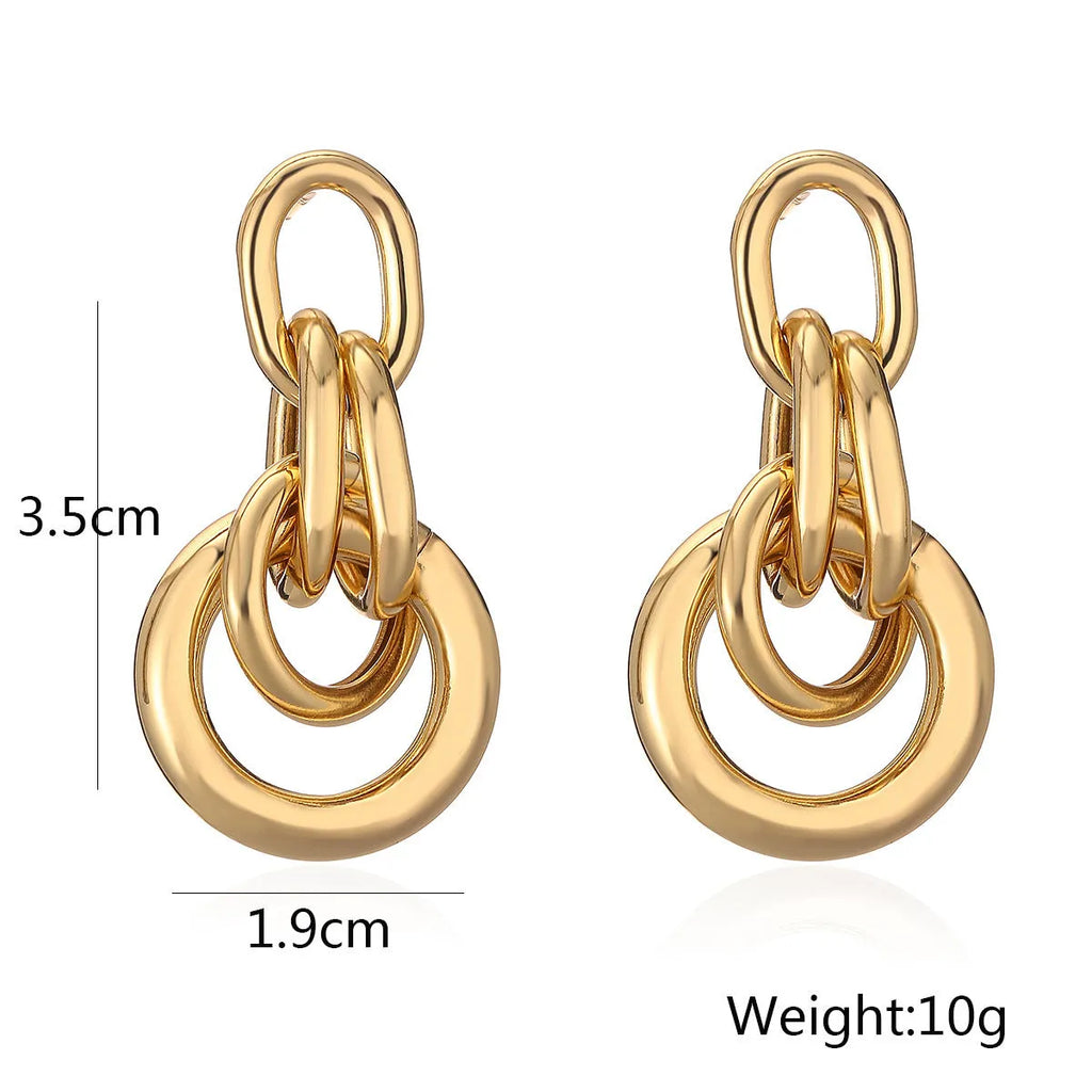 A pair of irregular geometric stud earrings in gold colour, made from copper.