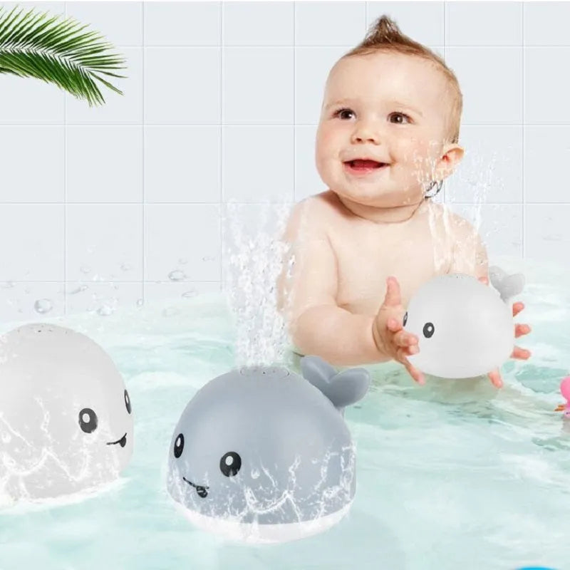 Electric whale-shaped bath toy with water spray, LED lights, and automatic water sensing for babies