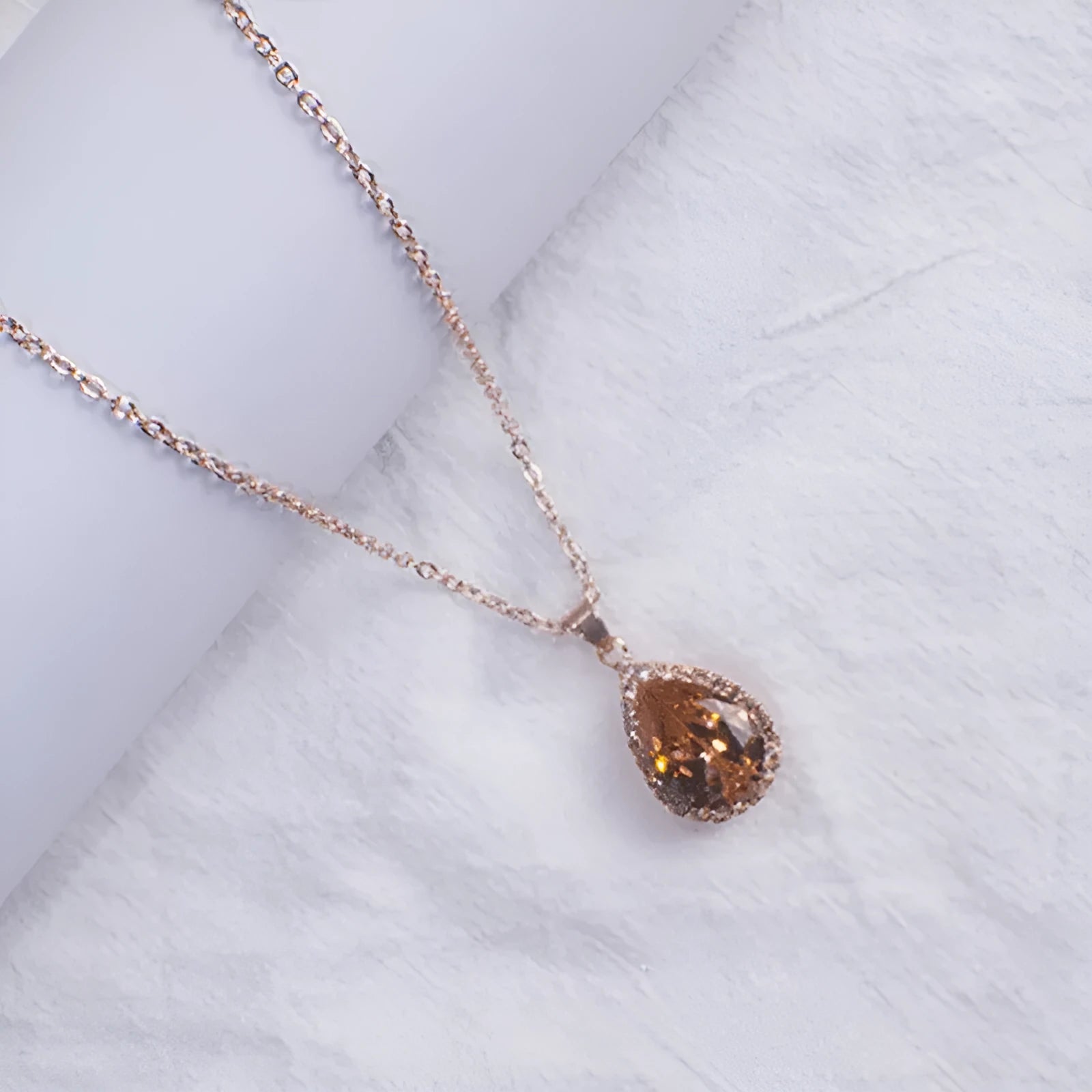 Women's rose gold drop shape necklace with rhinestone details on an alloy chain.