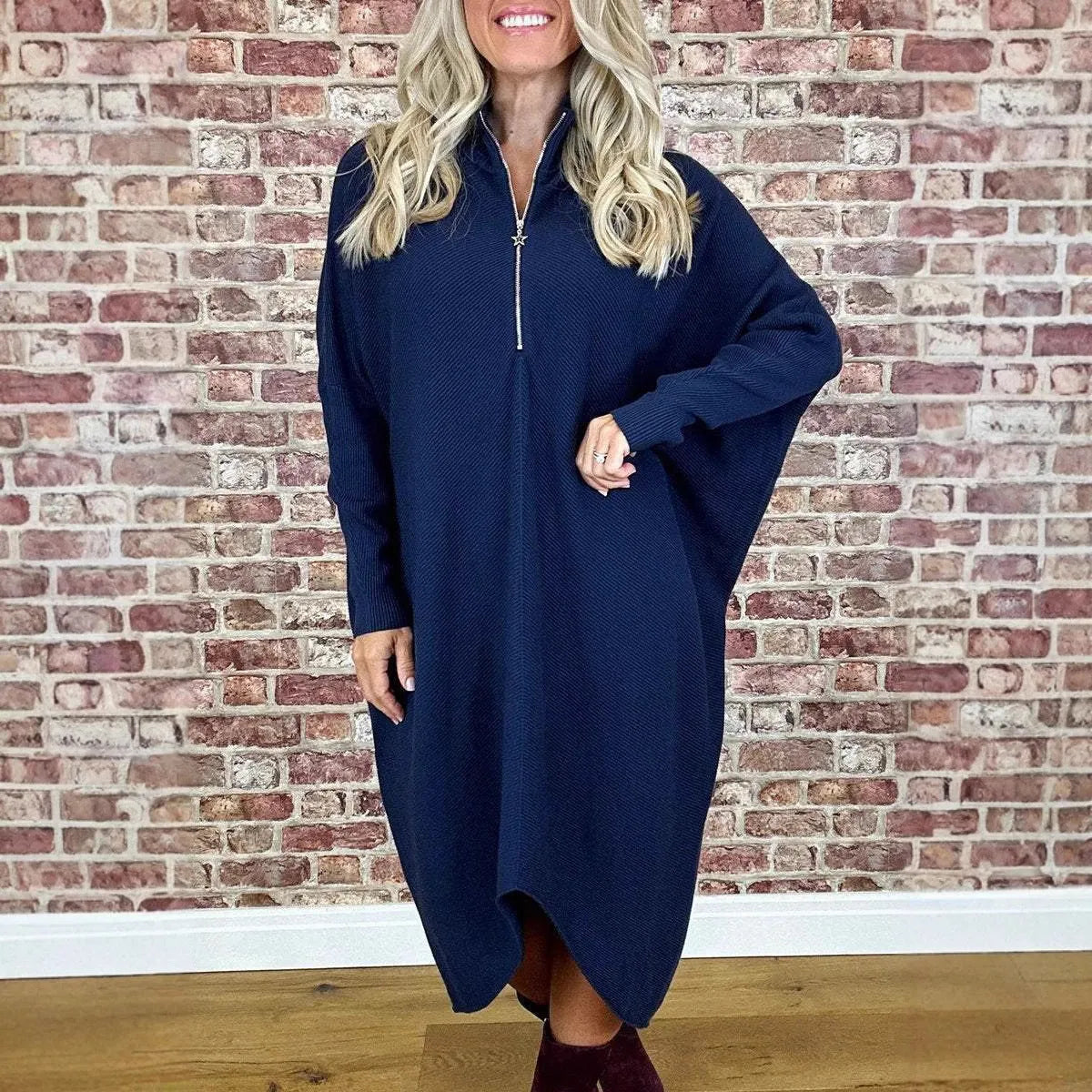 Women's solid colour knitted loose dress with raglan sleeves and a front zip.