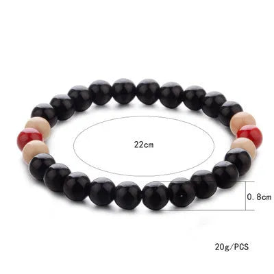 Natural stone bead bracelet with lava stones on a wrist, showing ethnic style and unisex design.