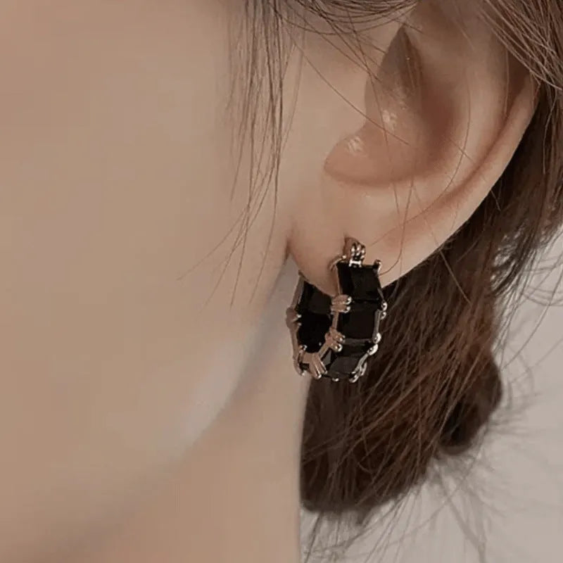 Geometric U-shape women's earrings with round black zircon crystals in gold electroplated settings