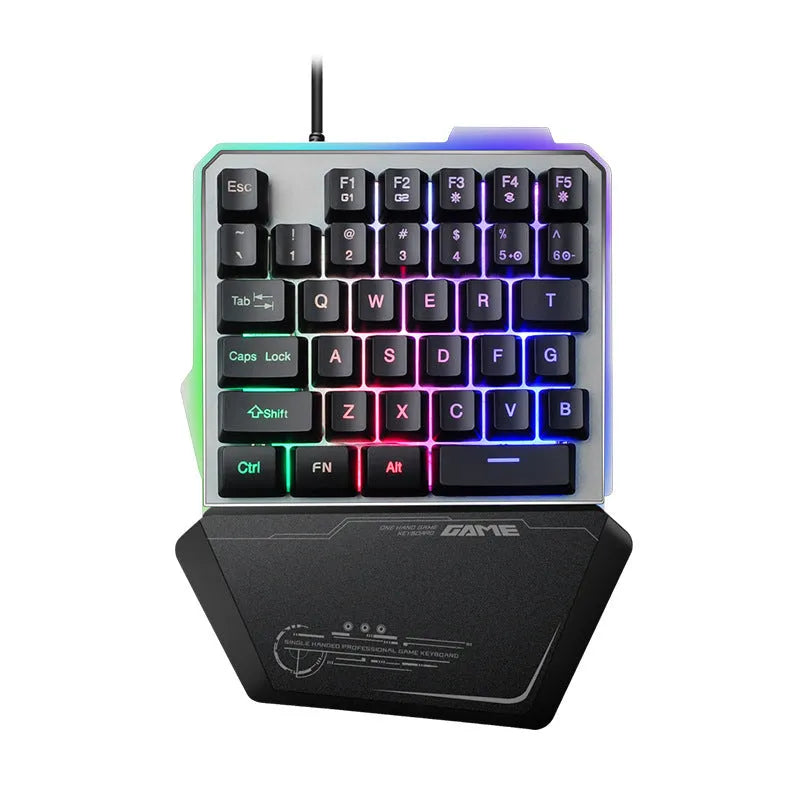 Black robotic one-handed mechanical keyboard with RGB backlighting on a desk