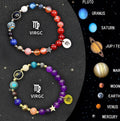 Two natural stone beaded bracelets showing different zodiac sign designs on a flat surface.