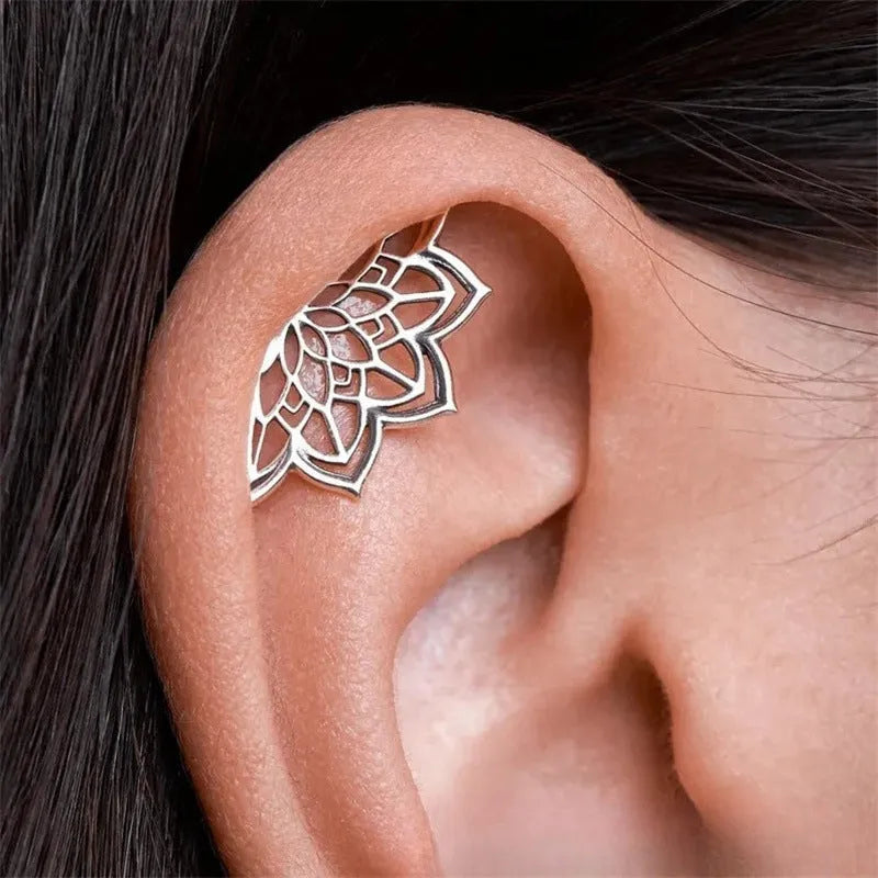 Spider web pattern stud earrings in gold and silver electroplated metal.