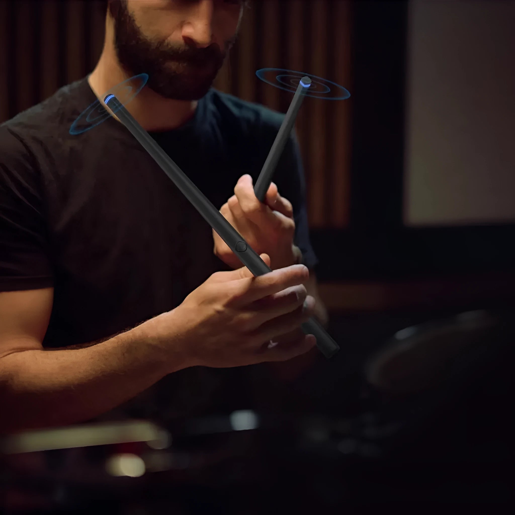 Somatosensory air drum kit with black host, two drumsticks, and LED lighting on a table
